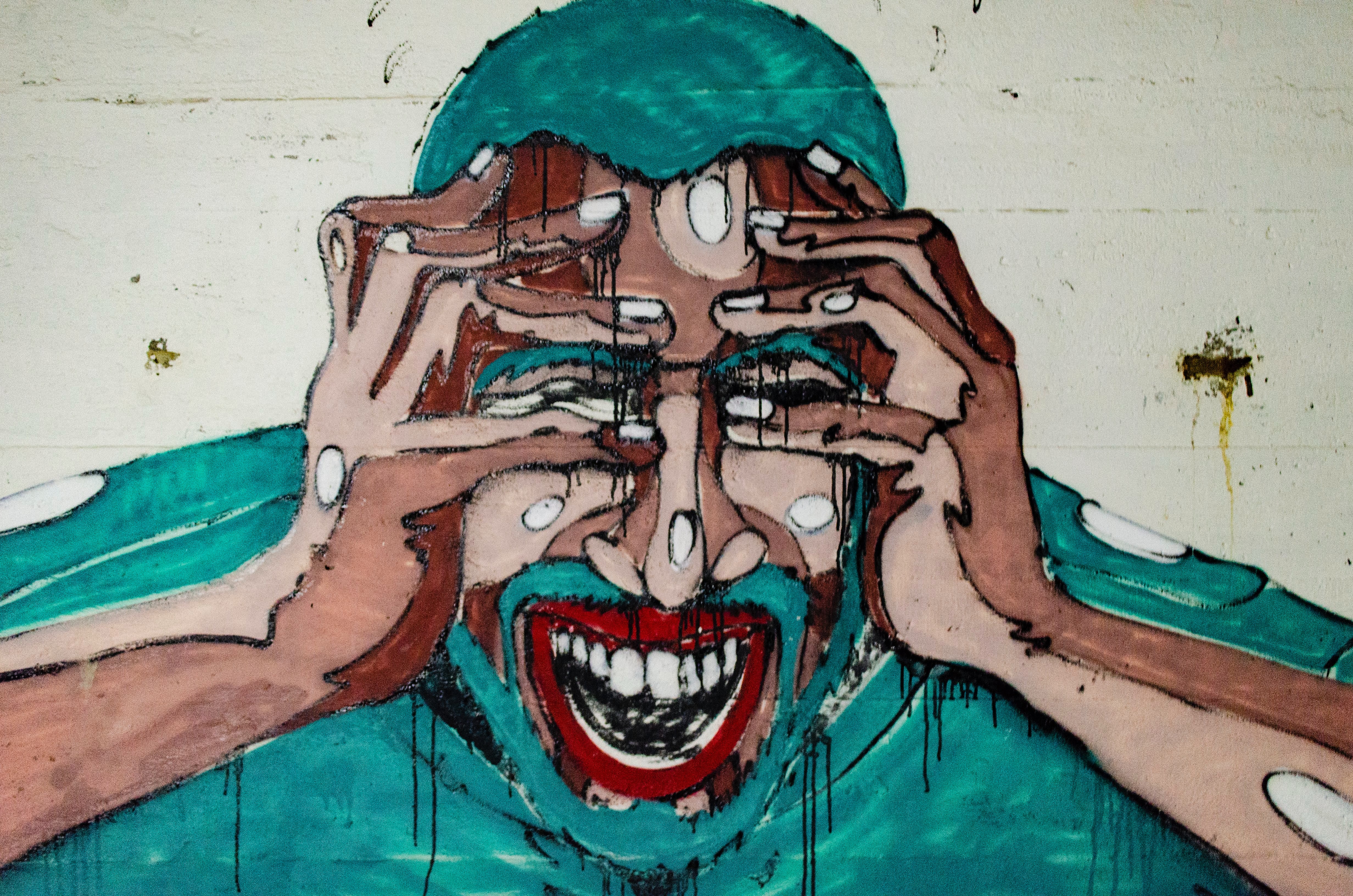 A mural painting of a man weeping